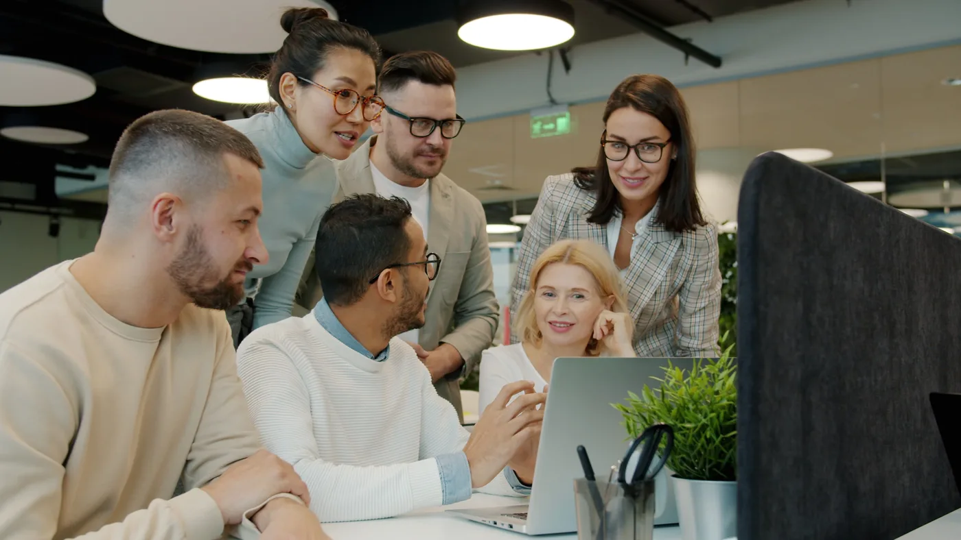 A team learning together around a computer